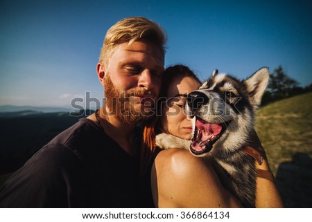 portrait photography couple and dog in her arms