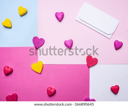 white envelope with colorful hearts around on a colorful background  top view close up decorations for Valentine's Day