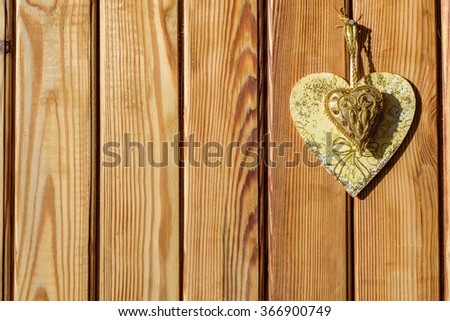 Two Valentines day hearts on rustic wooden wall with copy space. 
