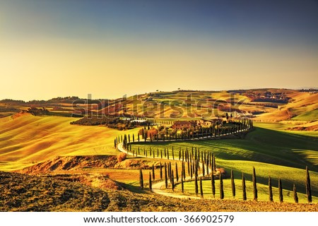 Tuscany, Crete Senesi rural sunset landscape. Countryside farm, cypresses trees, green field, sun light and cloud. Italy, Europe. Royalty-Free Stock Photo #366902579