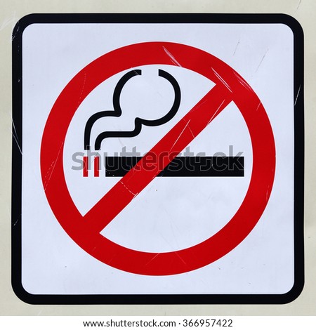 A grungy No Smoking signboard.
