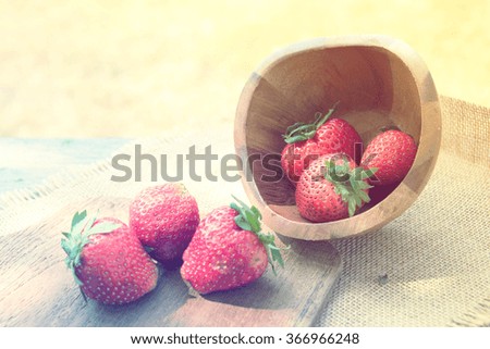 Vintage Ripe red strawberries  in a bowl on wooden table
