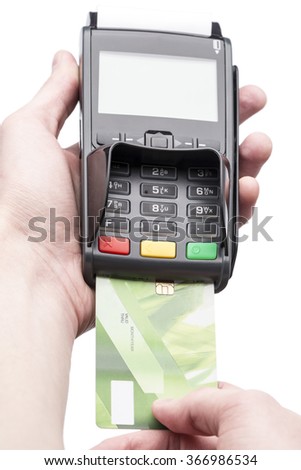 Man's hand holding a bank card on POS-terminal