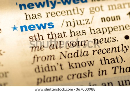 Close-up of word in English dictionary. News, definition and transcription