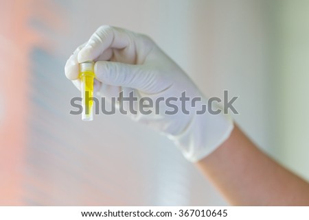 Picture of scientist looking at DNA in test tube in laboratory, Concept of science and technology
