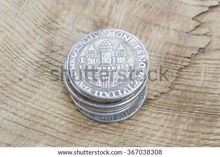 Medieval European silver coins on wooden bank