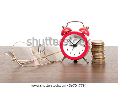 Alarm clock with stack of coins