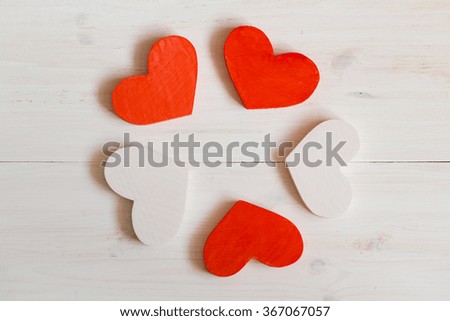 Red and white hearts on white wooden background. Image of Valentines day
