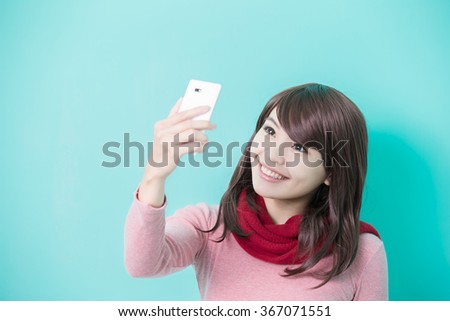 Young beautiful woman wearing winter clothing and photo selfie, asian beauty
