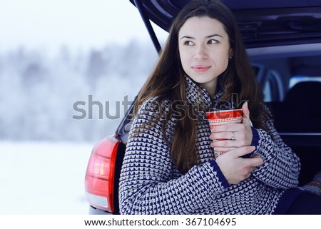 girl outside winter with cup of hot drink
