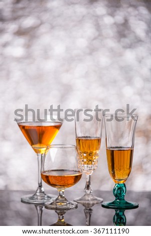 glasses with red liqueur on bokeh background
