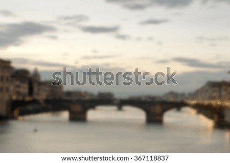 Defocused background with the river Arno in Florence in sunset time. Intentionally blurred post production for bokeh effect.