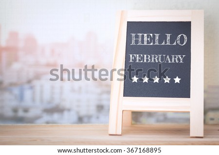 Concept HELLO FEBRUARY message on wood boards