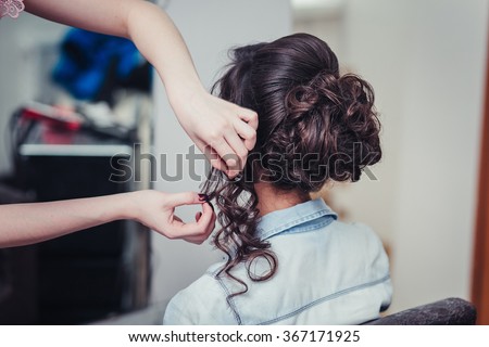 Closeup hairdresser coiffeur makes hairstyle. Royalty-Free Stock Photo #367171925