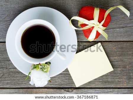 Romantic breakfast on Valentine's Day. Cup of coffee and heart shape cookies, white rose decoration, sticker for text. Toned image