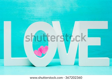 Word Love and pink hearts on blue wooden rustic backgound for Va
