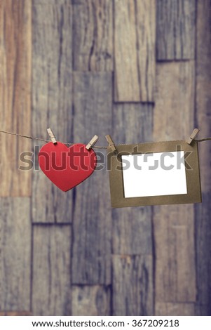  blank instant photos hanging on the clothesline with red heart