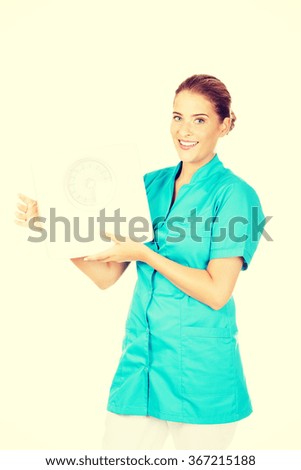 Young doctor or nurse holding weight
