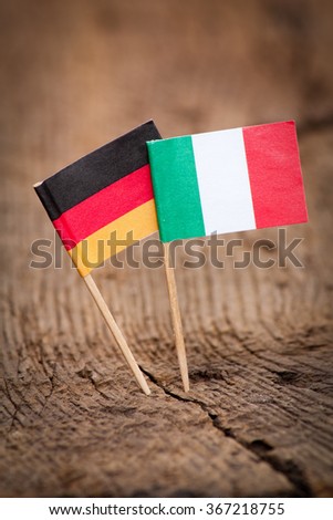 Flags of Italy and Germany on wooden background