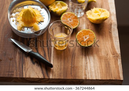 Orange Juice on a wooden background with cut oranges 