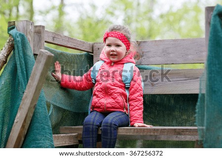Pretty little girl relax at beauty summer landscape background. Child walking through a forest. Active leisure with kids in nature.