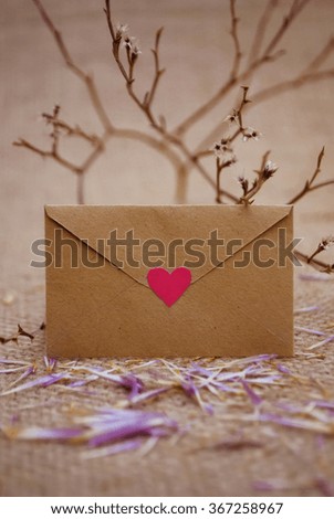 Romantic envelope with heart and love letters on fabric background. The best present for valentines day.