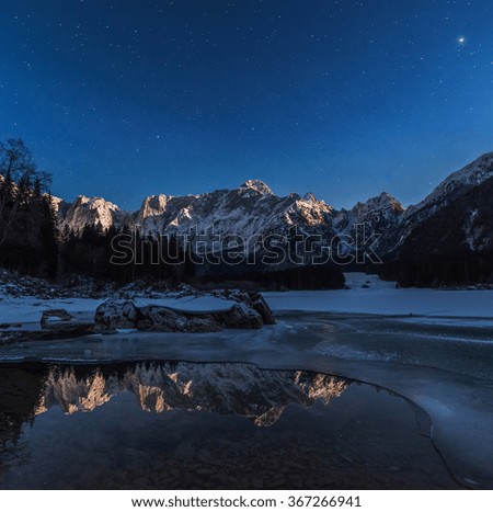 Reflections in the frozen lake at night