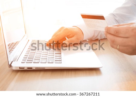 Businessman shopping online with a credit card