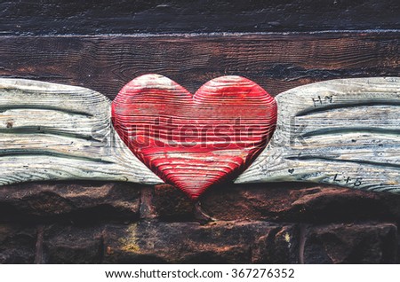 Carved wooden heart with an inscription in German "forever"