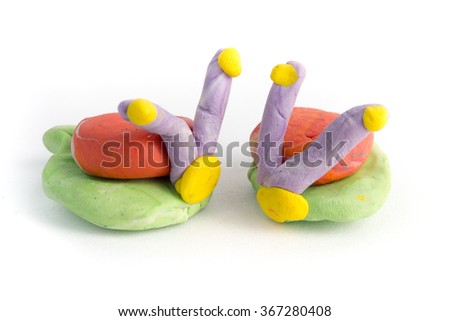 Kid's modelling snails clay model isolated on white