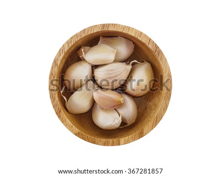 Garlic on wooden bowl top view of white background Royalty-Free Stock Photo #367281857