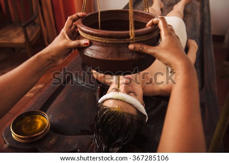 Caucasian woman having Ayurveda shirodhara treatment in India Royalty-Free Stock Photo #367285106