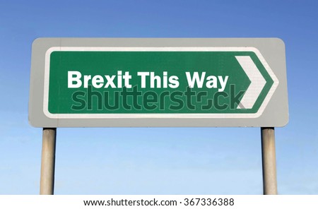 Green road sign with the message of an EU Crisis regarding a UK Brexit This Way concept against a blue sky background 