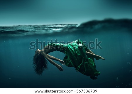 Woman floats underwater Royalty-Free Stock Photo #367336739