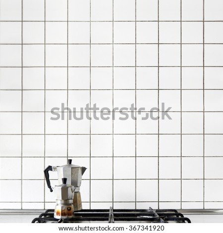 Moka pots on the stove on white tiles background Royalty-Free Stock Photo #367341920