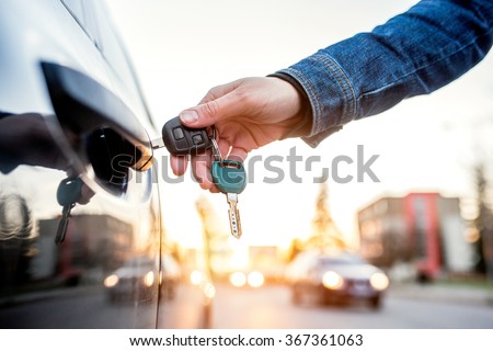 Woman with car key Royalty-Free Stock Photo #367361063