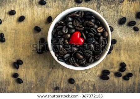 Closeup of coffee beans in vintage kitchen staff on rustic background. Toned image