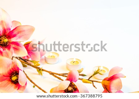 Spa flowers and candles on white background