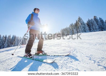 ski in Alps, winter sport, young skier on the slope in sunny day