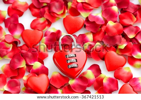 Padlock heart-shape on a background of red petals