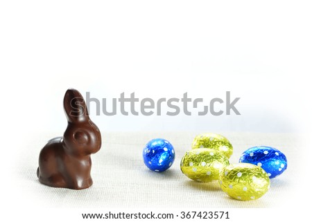 Colourful Easter chocolates:  small eggs and bunny rabbit. Isolated on white