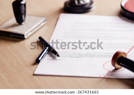 Notary pen lying on testament. Notary public working accesories Royalty-Free Stock Photo #367431665