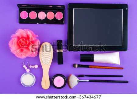 tablet comb lipstick on a purple background