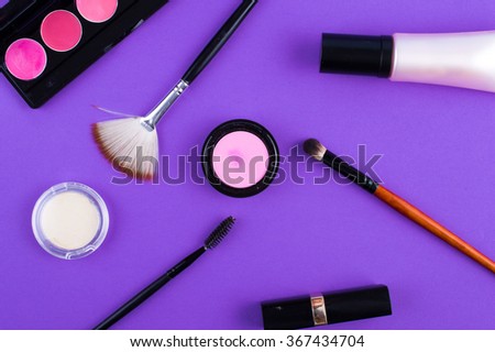 cosmetics brush lipstick shade on a purple background