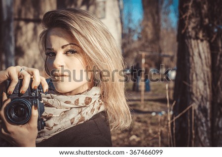 Portrait of beautiful young woman with old retro camera,horizontal photo