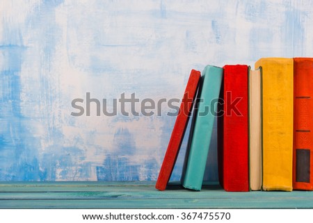 Composition with old vintage colorful hardback books, diary on w