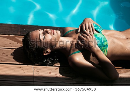 girl take sunbath by pool, hot summer day, natural light