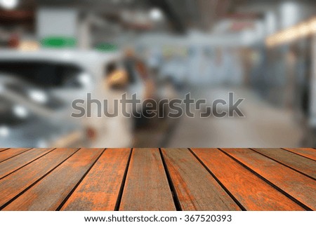 blurred image wood table and abstract of the car parking