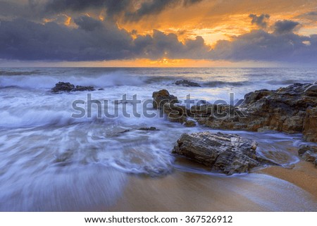 Sunrise with wave at Kemasek Beach taken with Slow Shutter. Soft Focus Motion Blur due to Slow Shutter Speed. Copy Space Area