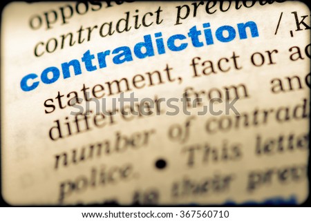 Close-up of word in English dictionary. Contradiction, definition and transcription